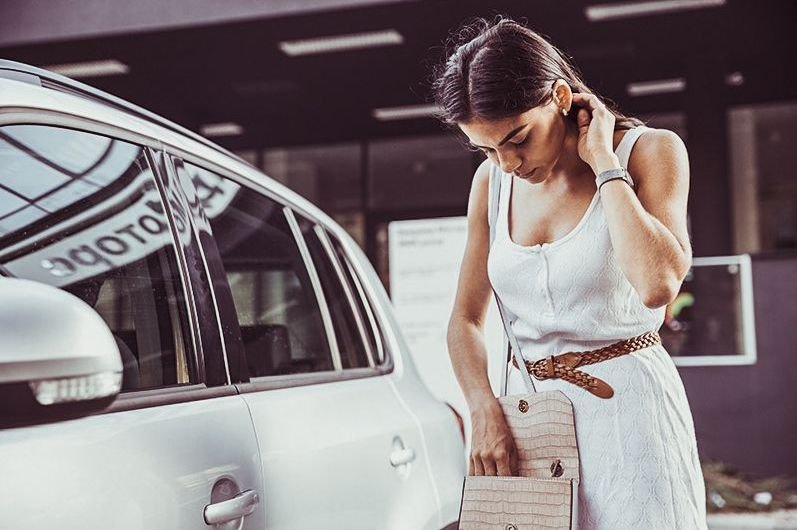 Mujer desesperada frente a su coche cerrado sin las llaves